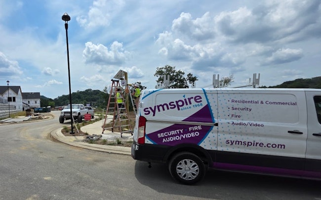 A Symspire technician team installs equipment at a new residential development site as the company’s service vehicle stands nearby. Symspire provides integrated security, fire, and audio/video systems for residential and commercial customers across Tennessee.