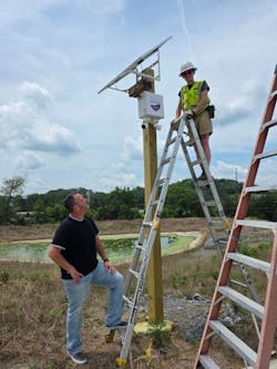 A Symspire technician installs a solar-powered, cellular-connected security camera at a construction site as company president James Ward looks on. A Symspire technician installs a solar-powered, cellular-connected security camera at a construction site as company president James Ward looks on.