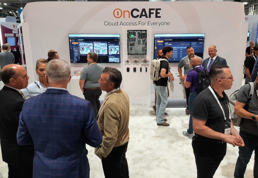Tom Cook, Executive Vice President of Sales, Marketing and Operations, North America, Hanwha Vision (far left), with attendees at the company&rsquo;s GSX 2025 booth showcasing the new OnCAFE cloud-based access control platform.