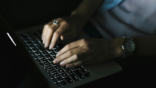 690e58ad250f0a2e9e860ba9 Cropwomanusinglaptopdarkroom