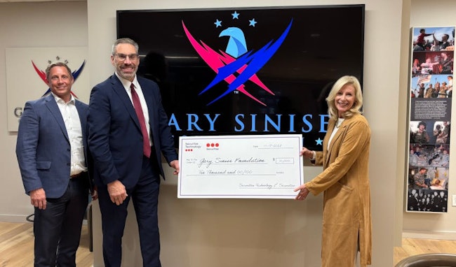 Securitas Technology team members present a donation check to the Gary Sinise Foundation, reflecting attendee engagement generated at the company’s GSX 2025 booth.
