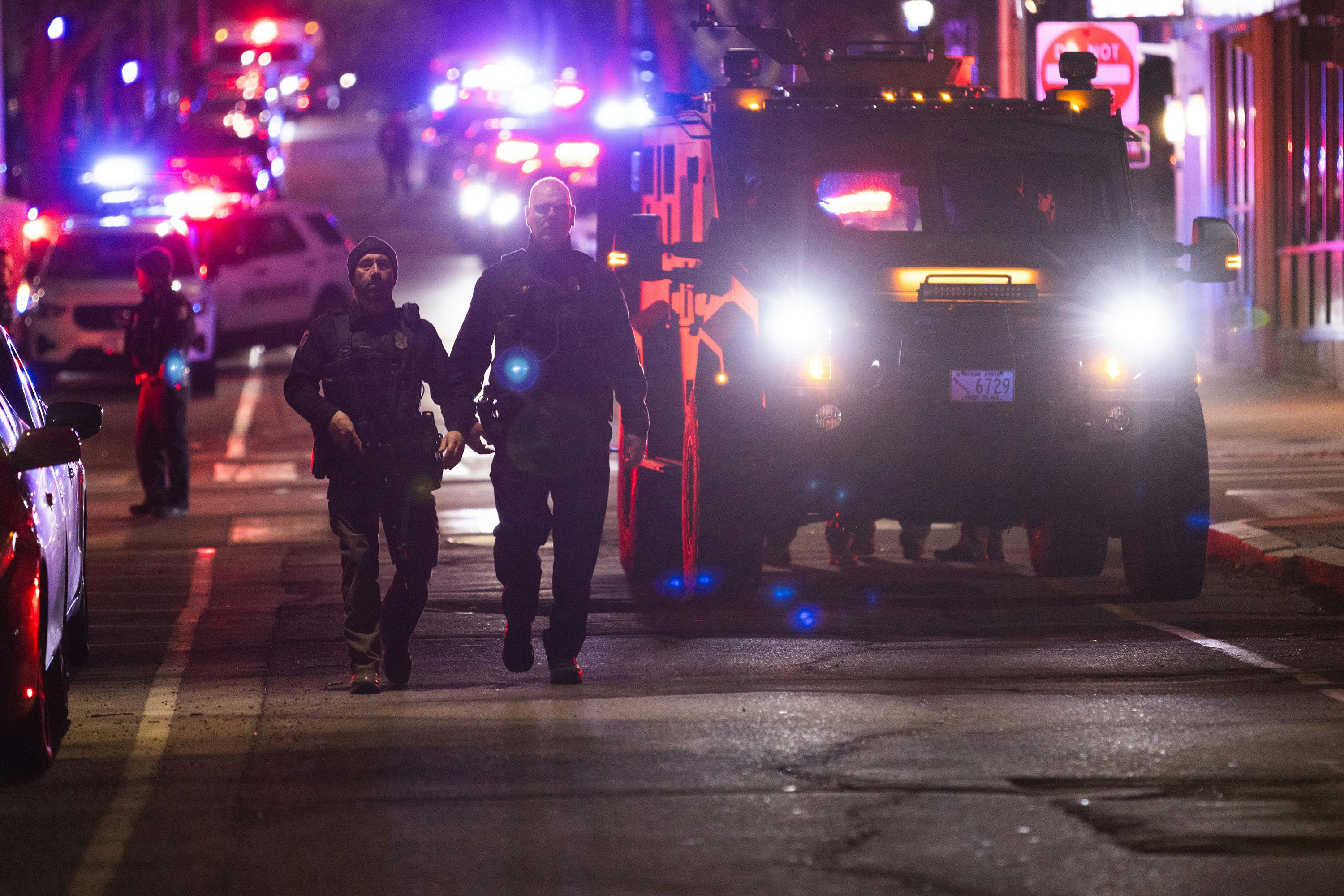 Police officers remain on the scene of a shooting that killed two and wounded at least eight at Brown University on Saturday, Dec. 13, 2025, in Providence, Rhode Island.