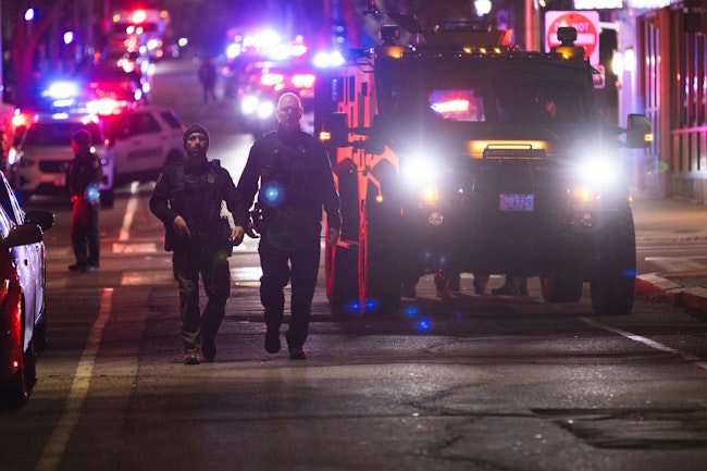Police officers remain on the scene of a shooting that killed two and wounded at least eight at Brown University on Saturday, Dec. 13, 2025, in Providence, Rhode Island.
