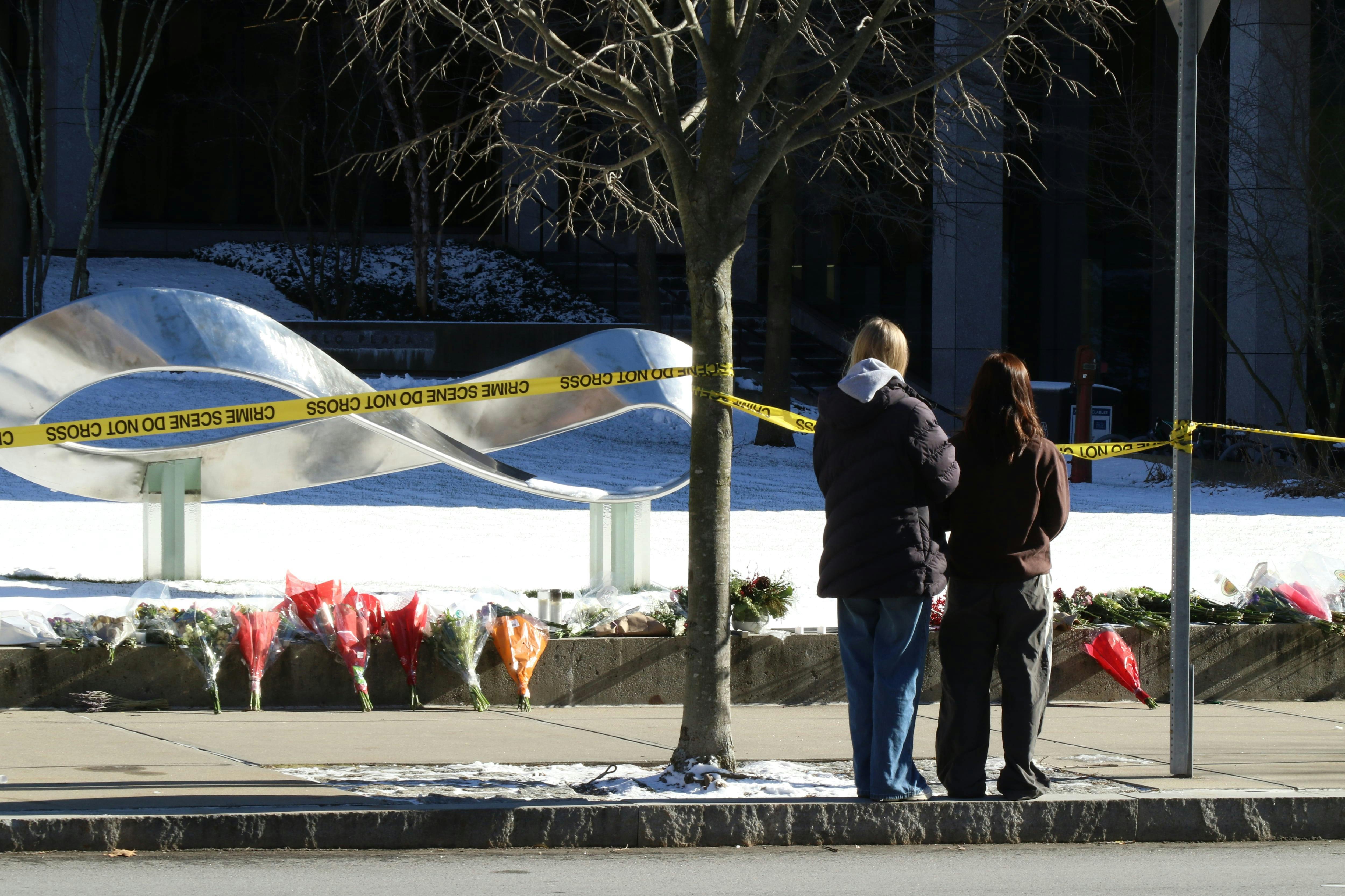 Flowers and candles were laid in front of Brown University's Barus and Holley building, seen here on Monday, Dec. 15, 2025, after a shooting left two dead and nine injured on Saturday.