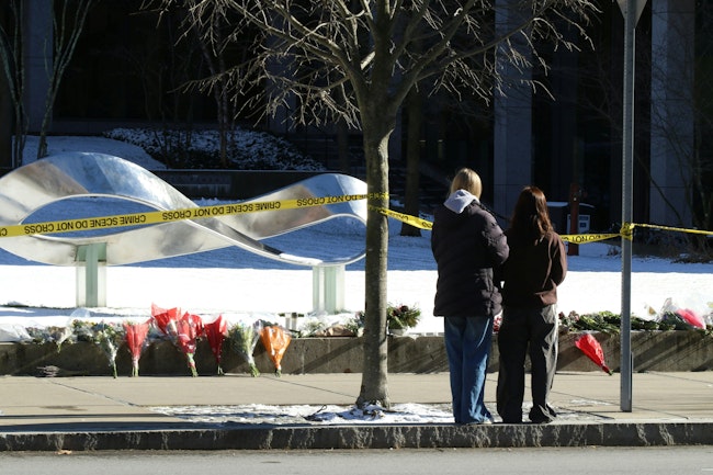 Flowers and candles were laid in front of Brown University's Barus and Holley building, seen here on Monday, Dec. 15, 2025, after a shooting left two dead and nine injured on Saturday.