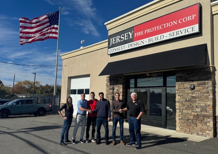 Representatives from Pye-Barker and Jersey Fire Protection Corp. celebrate the acquisition at Jersey Fire's West Deptford, N.J., headquarters.