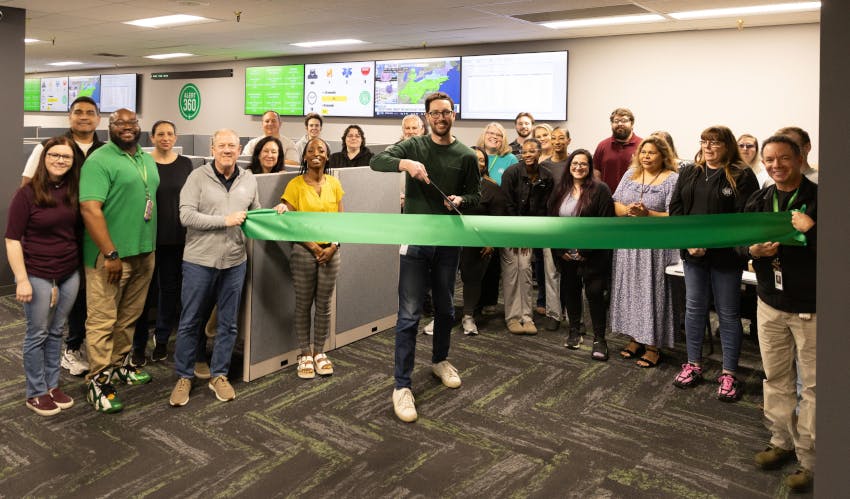 Executives and employees from Alert 360 participate in a ribbon-cutting ceremony for the company&rsquo;s new alarm and video monitoring center at its Tulsa headquarters.