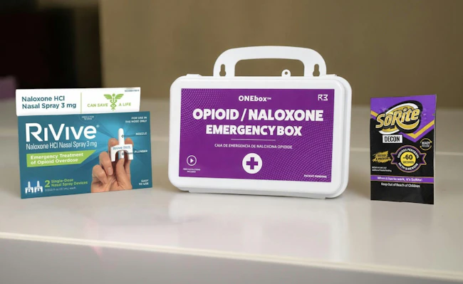ONEbox emergency response station featuring integrated overdose response tools alongside SoRite DECON towelettes and canister for rapid narcotic decontamination in public safety settings.
