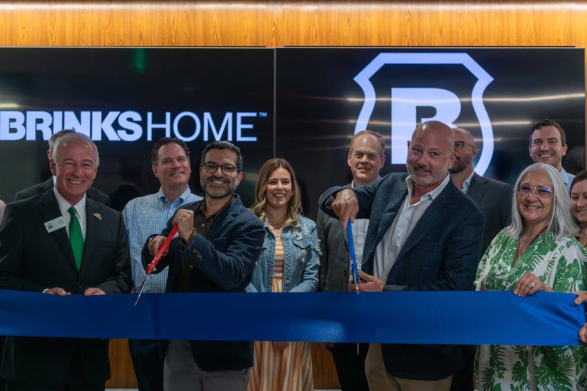 Brinks Home executives, employees and local officials participate in a ribbon-cutting ceremony celebrating the opening of the company's new headquarters in Farmers Branch, Texas, on June 9.