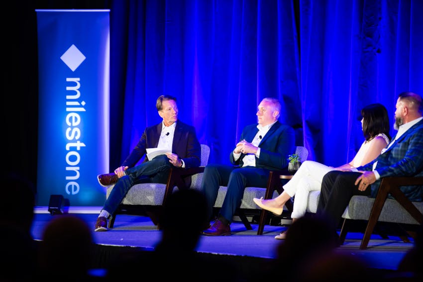 SecurityInfoWatch Editor-in-Chief Rodney Bosch (left) moderates the 'No Hype Allowed: An Honest Conversation About AI' panel during Milestone XPerience Days 2026 in Las Vegas. Panelists included John O'Connor, Managing Director of Administrative Services and Operations at Harvard Business School, and Dan O'Neill, President and CEO of Advanced Data Risk Management.
