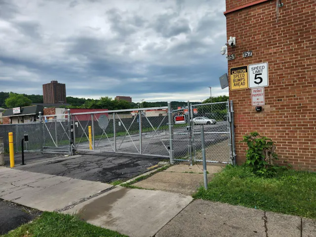 The redevelopment's parking entrance is integrated with license plate recognition technology and other security measures designed to control vehicle access.