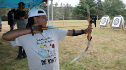 A young participant takes part in an archery activity at Children’s Burn Camp, which will receive support from funds raised during the Fire & Security Executive Club’s annual dinner Nov. 2 in New York City.