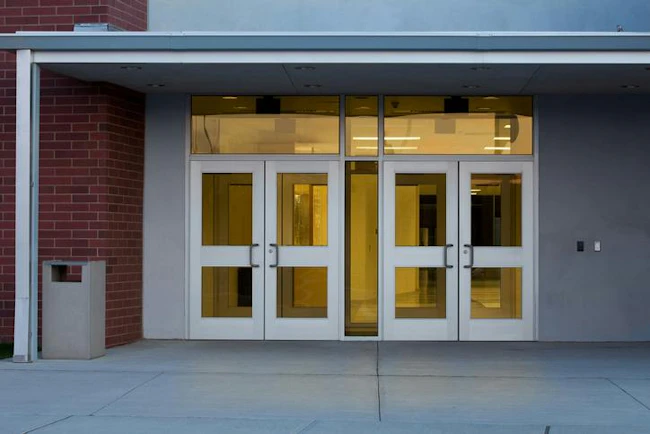 Locked school entrances with glass panels can present vulnerabilities that conventional access-control measures alone may not address, a concern underscored by the shootings at Sandy Hook and Silver Rail elementary schools.